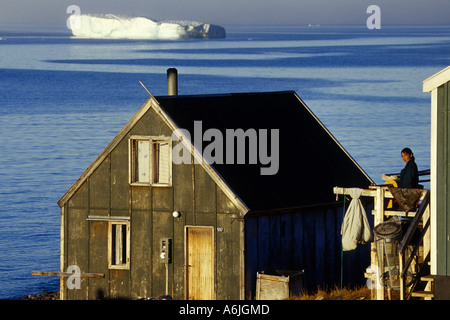 early morning, Inuit woman in front of her house, Denmark, Greenland, Avannaarsua, Siorapaluk Stock Photo