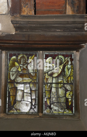 Stained glass windows depicting two musical angels in Church of All Hallows at Tillington West Sussex. Church was built in 1807 Stock Photo