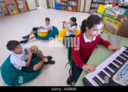 School music class band junior school pupils 11-14 years music practice group playing together with various instruments in informal musical study Stock Photo