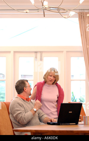 British business man and woman casual clothes working in office London UK talking about debts and savings with online banking Stock Photo