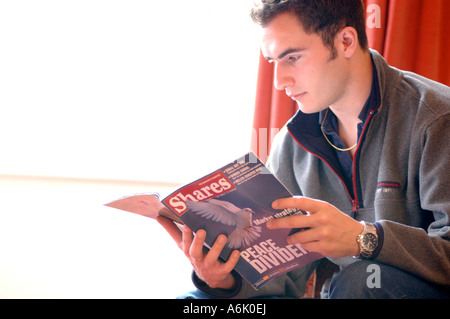 British business man reading financial magazine office London UK Stock Photo
