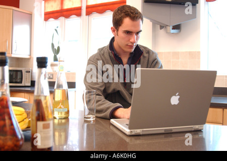 British business man remote working from home London UK with apple mac Laptop Stock Photo