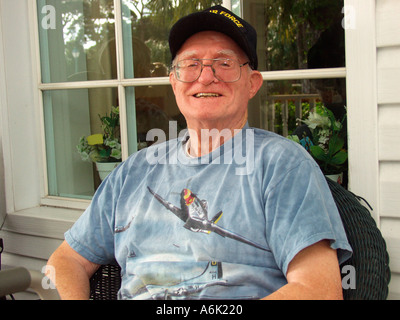 Smiling elderly man sitting on the porch of a nursing home Stock Photo