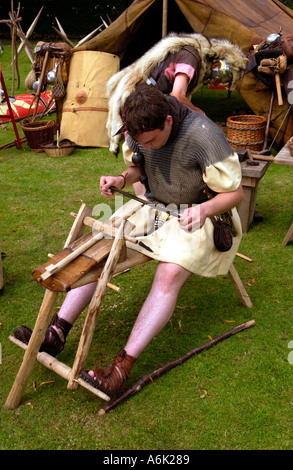 Ermine Street Guard give a display of arrow making in the Roman Amphitheatre in Caerleon Newport Gwent South Wales UK Stock Photo