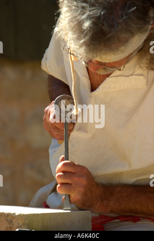 French Stonemason, stone sculptor, man in french period costume carving stone at medieval festival, Monflanquin Aquitaine South West France europe eu Stock Photo