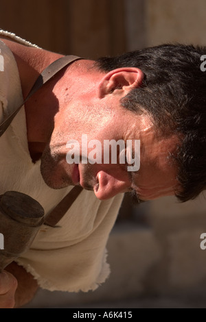 French Stonemason, stone carver man in period costume, closeup of face, blurred background Monflanquin Aquitaine South West France eu Stock Photo