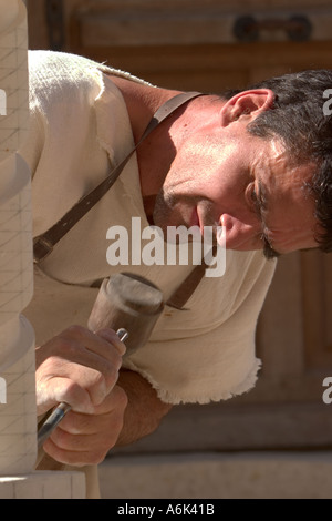 French Stonemason, man in french period costume carving stone spiral at french medieval festival in Monflanquin Aquitaine South West France europe eu Stock Photo