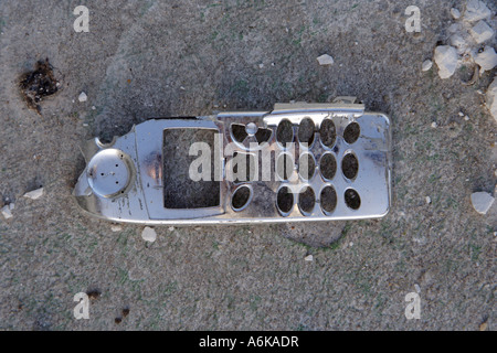 broken mobile phone fascia lying on the pavement Stock Photo