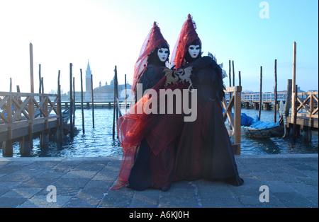 Costumed Couple on Piazzetta Venice during Carnival 2007 with the Church of Redentore in the background Stock Photo