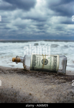 100 dollar notes as a message in the bottle, Southampton Beach, New York, USA Stock Photo