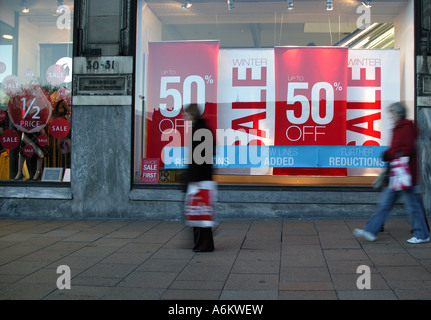 Female Shoppers pass Sale signs in shop window, Princes Street, Edinburgh Scotland UK Europe 2007 Stock Photo