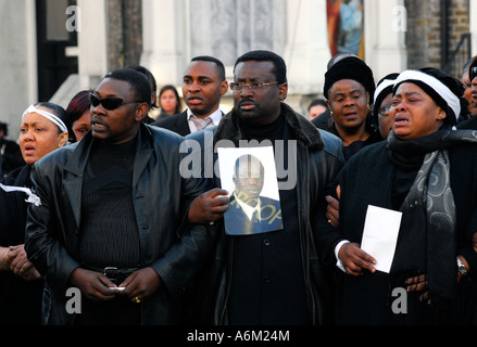 Kodjo s mother far right and friends of Kodjo Yenga mourn his death in Hammersmith Grove west London Stock Photo