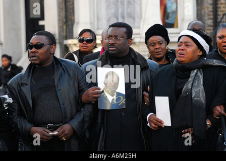 Kodjo s mother far right and friends of Kodjo Yenga mourn his death in Hammersmith Grove west London Stock Photo