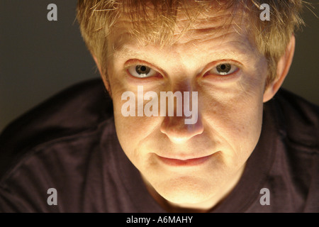 Closeup Portrait of Blonde Man Looking in Camera Lens Stock Photo