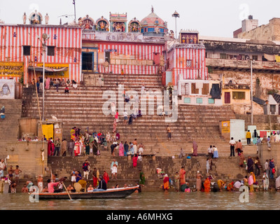 Pilgrims on steps of Kedar Ghat bathing washing in holy waters of River Ganges Varanasi Uttar Pradesh India Stock Photo