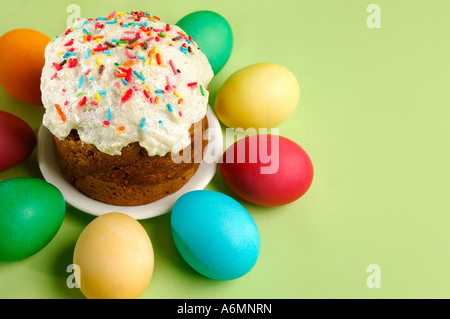 Easter cake and colorful Easter eggs on green Stock Photo