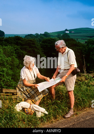 elderly hikers consulting map man woman walkers Stock Photo