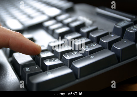 finger on computer keyboard Stock Photo