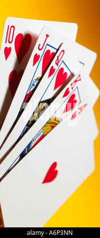 flush-hand of cards - panoramic format, portrait on a yellow background Stock Photo
