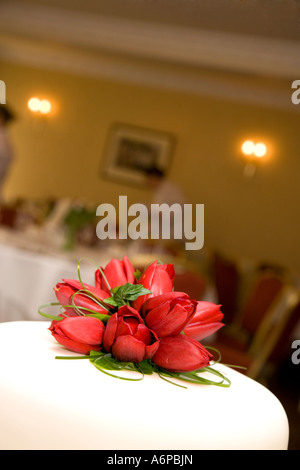 Red Tulips as decoration on top of wedding cake Stock Photo