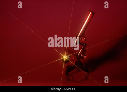 Old brass microscope with starburst and coloured background Stock Photo