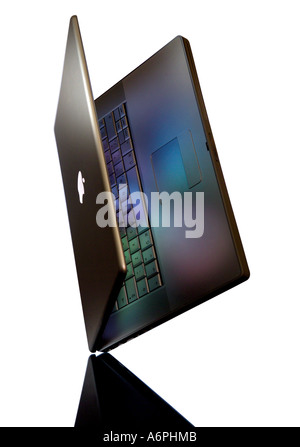 AN APPLE MAC LAPTOP BALANCING ON ONE CORNER WITH COLOURED REFLECTIONS ON A WHITE BACKGROUND Stock Photo