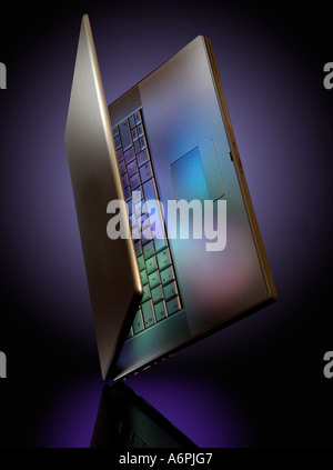 A LAPTOP BALANCING ON ITS CORNER WITH COLOURED REFLECTIONS Stock Photo