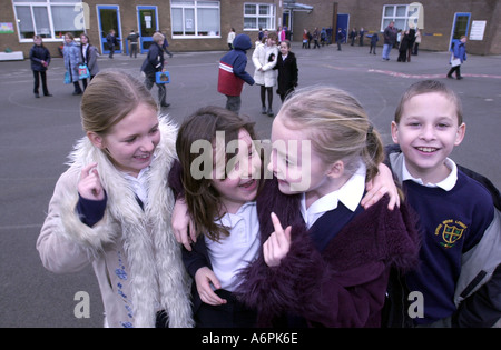 Children play games in the playground of their school UK Stock Photo