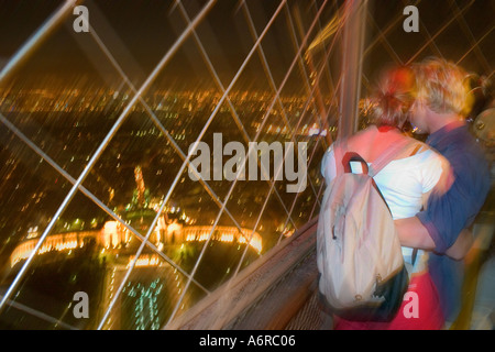 Young couple embracing and admiring Palace Challiot view top observatory Eiffel Tower Paris France Flash & ambient light Europe Stock Photo