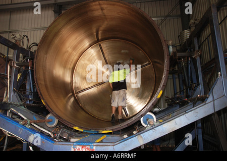 worker cleans mould for rainwater tank Stock Photo