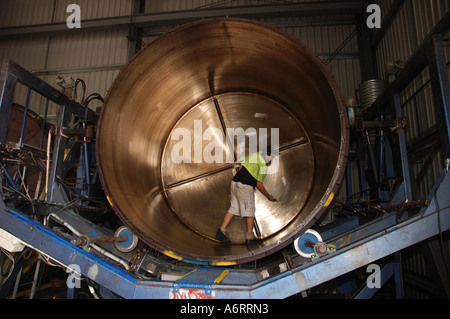 worker cleans mould for rainwater tank Stock Photo