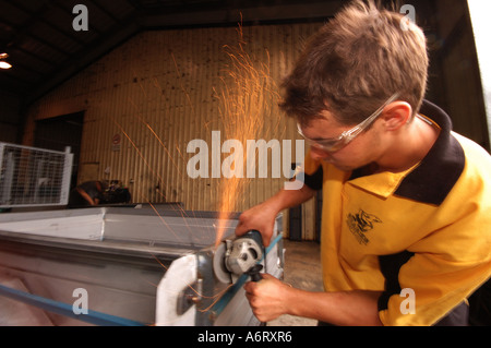 young worker with angle grinder Stock Photo