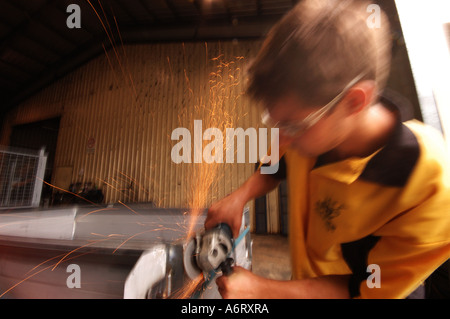 young worker with angle grinder Stock Photo
