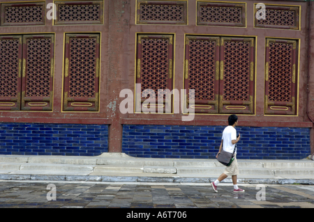 China Beijing The Temple Of Heaven Young Man Walking By The Qinian Dian Hall Of Praying For Good Harvest Stock Photo