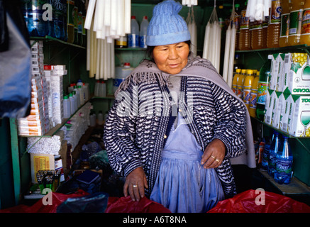 Old woman in tiny shop in Potosi Bolivia selling dynamite coca leaves and other goods to miners working in local Silver mine Stock Photo