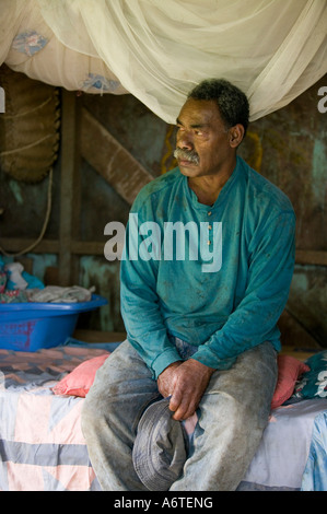 A Fijian man in his hut in Bukaya village, Fijian Highlands Stock Photo