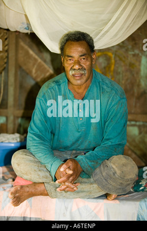 A Fijian man in his hut in Bukaya village, Fiji Stock Photo