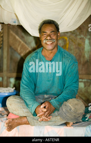 A Fijian man in his hut in Bukaya village, Fiji Stock Photo