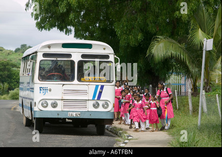 Indian children getting on the school bus in Fiji Stock Photo