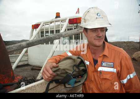 Mine engineer worker leaning on his vehicle Stock Photo