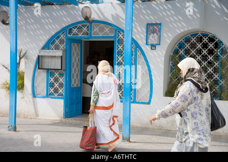 Women in Traditional Clothes Shopping in Houmt Souk Djerba Tunisia Stock Photo