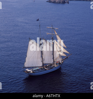 Aerial image of the 'Sir Robert Baden Powell' modern sailing clipper, under sail near Arenal de Castell, North East Menorca Stock Photo