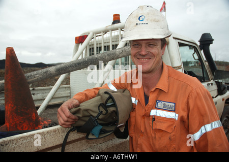 Mine engineer worker leaning on his vehicle Stock Photo