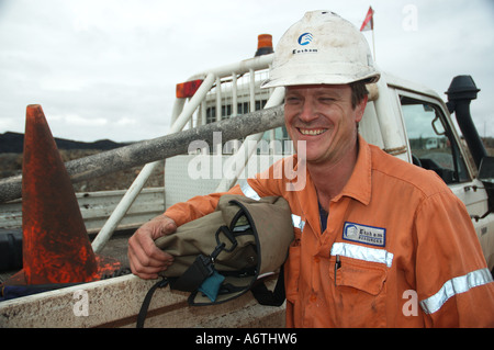 Mine engineer worker leaning on his vehicle Stock Photo