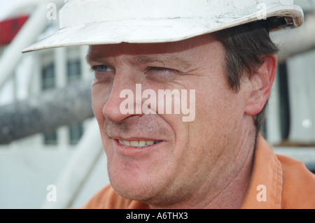 Mine engineer worker leaning on his vehicle Stock Photo