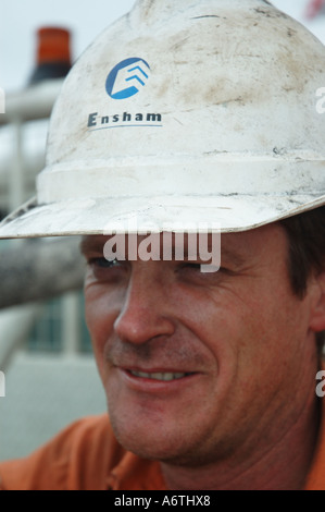 Mine engineer worker leaning on his vehicle Stock Photo