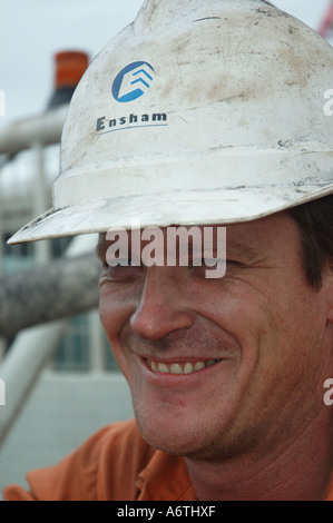 Mine engineer worker leaning on his vehicle Stock Photo