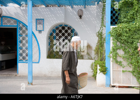 Tunisian Man in Traditional Dress in Market Place Tunisia Djerba Houmt Souk Stock Photo