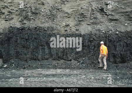 Miner engineer inspects coal seam open cut coal mine Queensland Australia Stock Photo