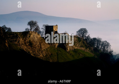 Early morning mist around Peveril Castle which lords it over the medieval township of Castleton which lies beneath it. Stock Photo